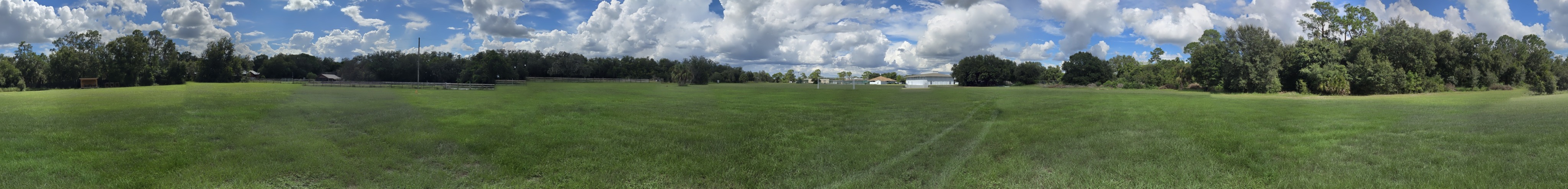 Wide panoramic view of the Camp Frontier sports field with sky and grass